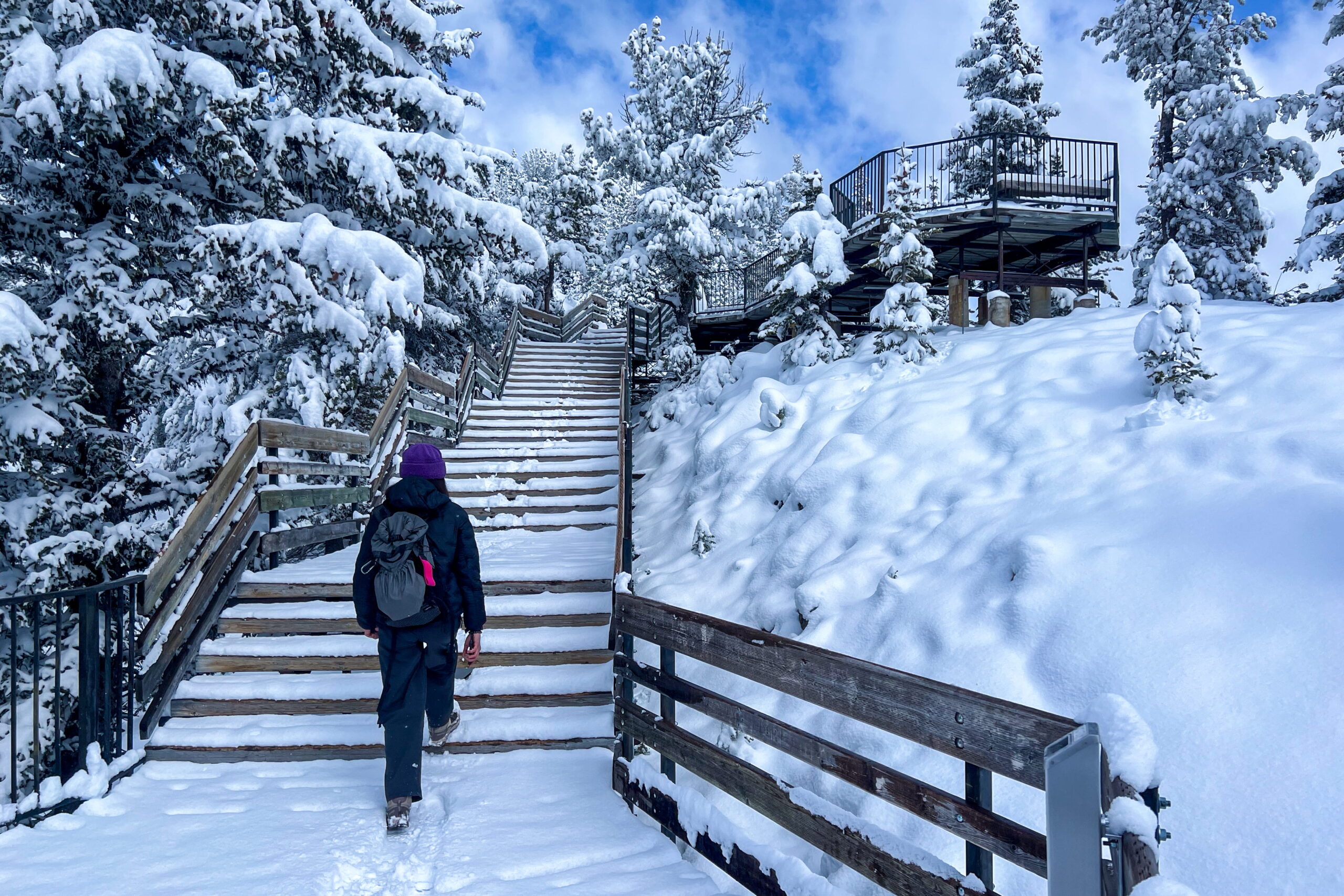 Woman walking on Sanson's peak broadwalk in snow