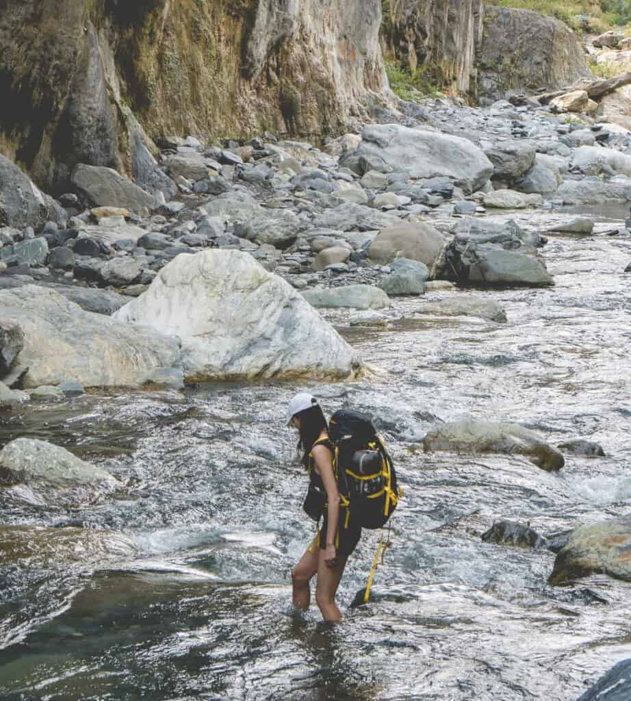 Woman across river in Taiwan's mountain.