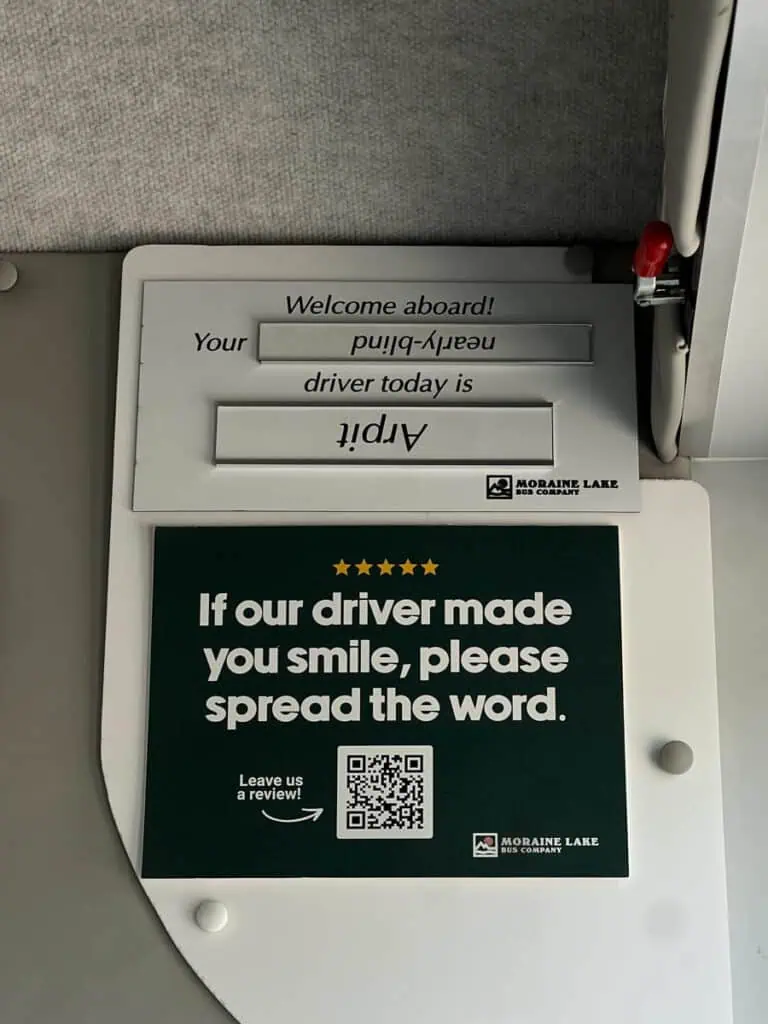 Bus driver sign on Moraine Lake bus company shuttle
