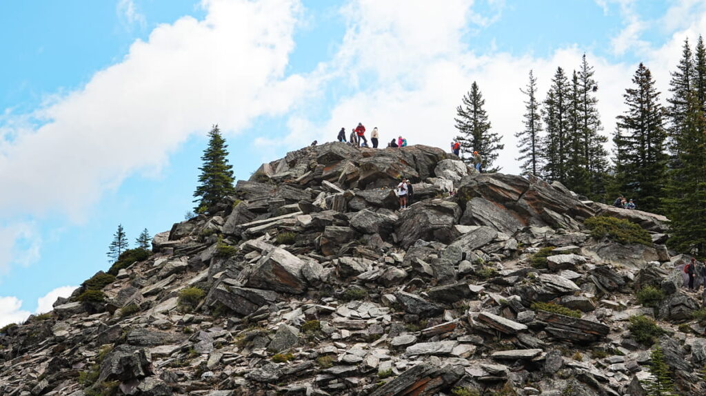 Visitors climbing Rockpile to take photo of Moraine Lake